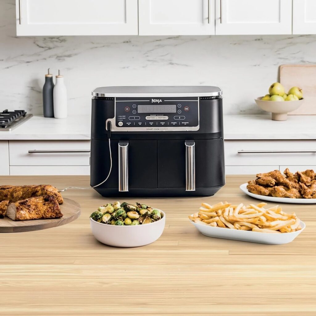 Ninja Foodi DZ550 DualZone air fryer with chicken, fries and Brussels sprouts