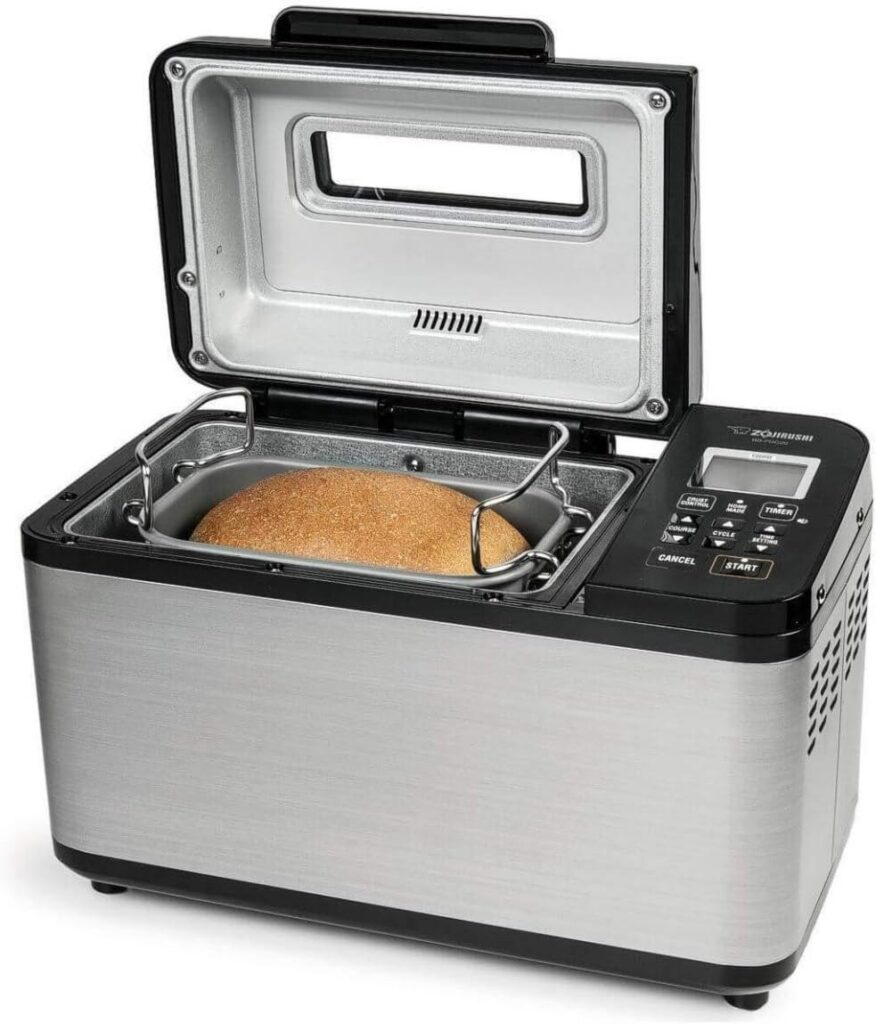 Zojirushi Virtuoso Plus breadmaker with lid open and a freshly baked loaf